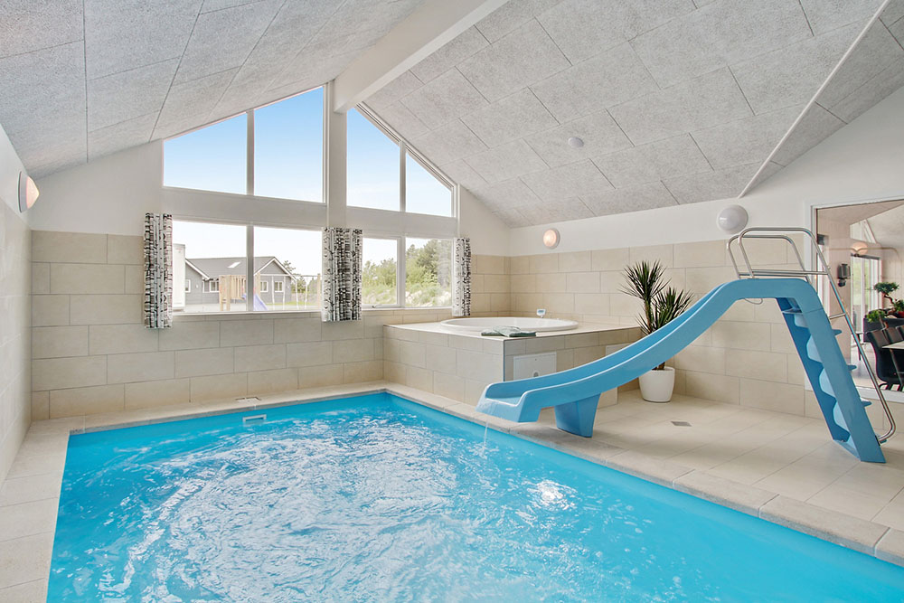 Das Ferienhaus 390 hat einen schicken Poolbereich mit Wasserrutsche, einem geräumigen, eingelassenen Whirlpool und einer Sauna.