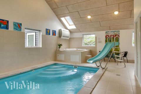 Der schöne Poolraum mit dem 18 m2 großen Pool (inkl. Wasserrutsche), dem Whirlpool und der Sauna, strotzt vor spannenden Details