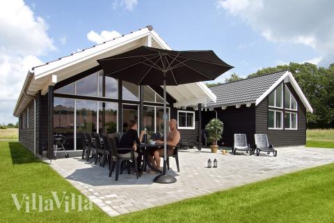 Der dänische Sommer lässt sich auf der großen Terrasse genießen. Für die Kleinsten stehen Sandkiste und Schaukeln parat