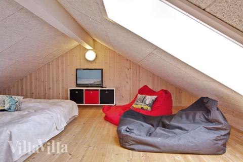 Der Dachgiebel ist als Kinderecke mit Matratzen und Flachbildfernseher mit DVD-Spieler eingerichtet
