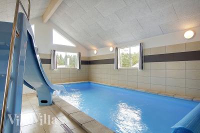Das Ferienhaus 330 hat einen schicken Poolbereich mit Wasserrutsche, einem geräumigen, eingelassenen Whirlpool und einer Sauna.