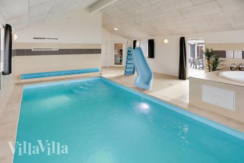 Das Ferienhaus 340 hat einen schicken Poolbereich mit Wasserrutsche, einem geräumigen, eingelassenen Whirlpool und einer Sauna.