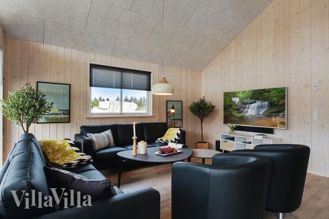 Der große, lichtdurchflutete Aufenthaltsraum im Luxusferienhaus Nr. 399 für 18.