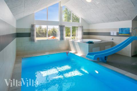 Das Ferienhaus 413 hat einen schicken Poolbereich mit Wasserrutsche, einem geräumigen, eingelassenen Whirlpool und einer Sauna.