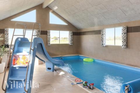 Das Ferienhaus 447 hat einen schicken Poolbereich mit Wasserrutsche, einem geräumigen, eingelassenen Whirlpool und einer Sauna.
