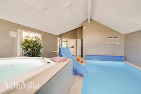 Das Ferienhaus 491 hat einen schicken Poolbereich mit Wasserrutsche, einem geräumigen, eingelassenen Whirlpool und einer Sauna.