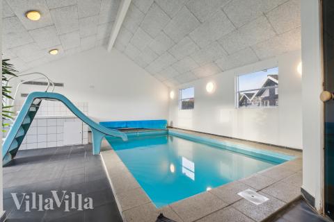 Das Ferienhaus 221 hat einen schicken Poolbereich mit Wasserrutsche, einem geräumigen, eingelassenen Whirlpool und einer Sauna.