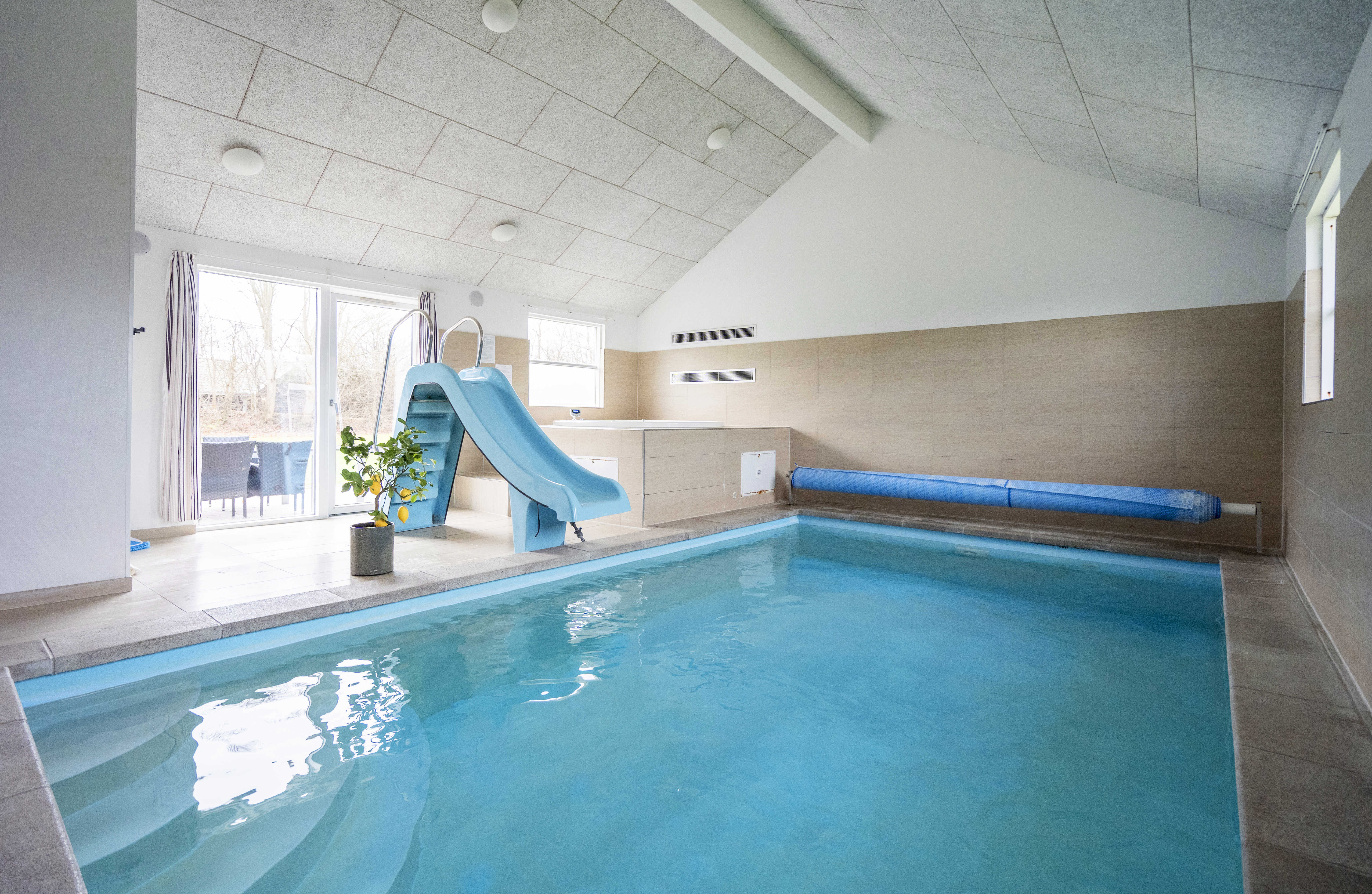 Das Ferienhaus 275 hat einen schicken Poolbereich mit Wasserrutsche, einem geräumigen, eingelassenen Whirlpool und einer Sauna.