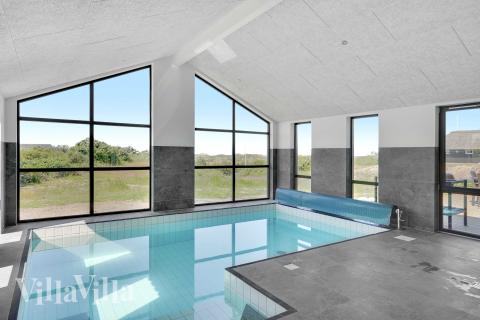 Das Ferienhaus 909 hat einen schicken Poolbereich mit Wasserrutsche, einem geräumigen, eingelassenen Whirlpool und einer Sauna.