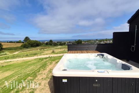 Genießen Sie den warmen Whirlpool im Luxusferienhaus Nr. 668 in Fünen und seine Inseln