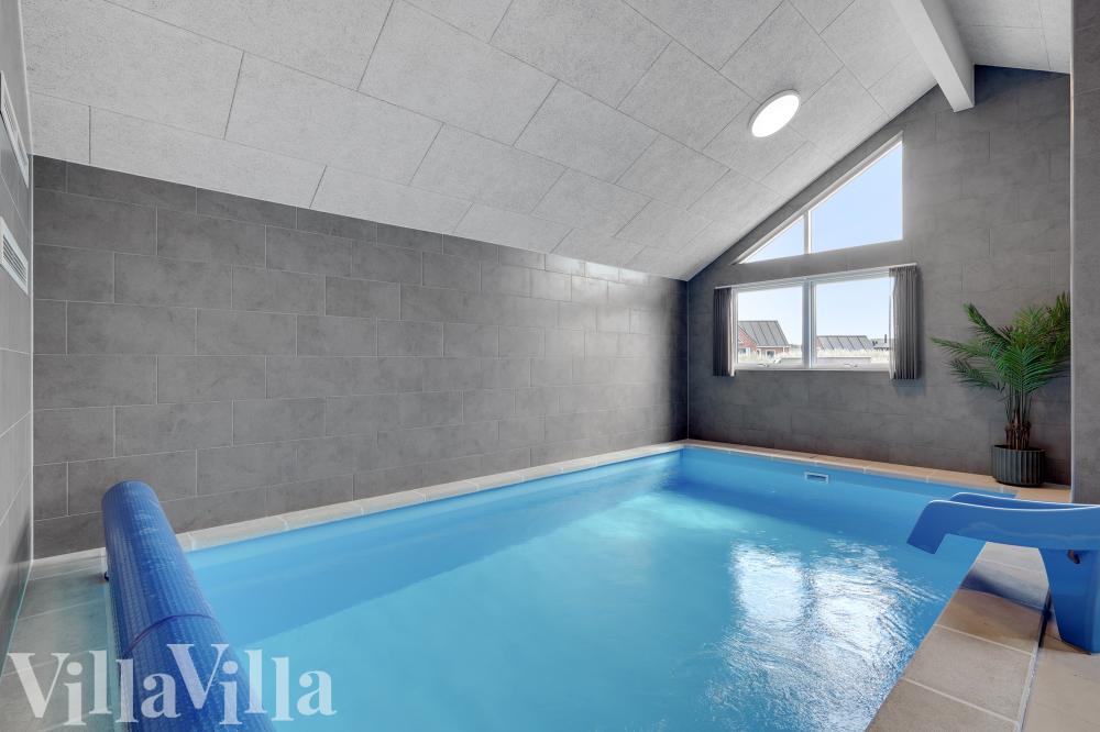 Das Ferienhaus 900 hat einen schicken Poolbereich mit Wasserrutsche, einem geräumigen, eingelassenen Whirlpool und einer Sauna.