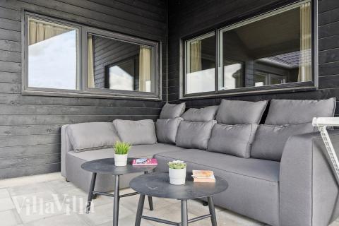 Genießen Sie einen Grillabend auf der Terrasse des Luxusferienhauses Nr. 655 in Fünen und seine Inseln