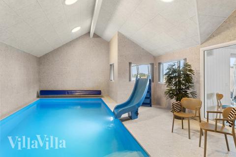 Das Ferienhaus 910 hat einen schicken Poolbereich mit Wasserrutsche, einem geräumigen, eingelassenen Whirlpool und einer Sauna.