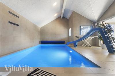 Das Ferienhaus 933 hat einen schicken Poolbereich mit Wasserrutsche, einem geräumigen, eingelassenen Whirlpool und einer Sauna.
