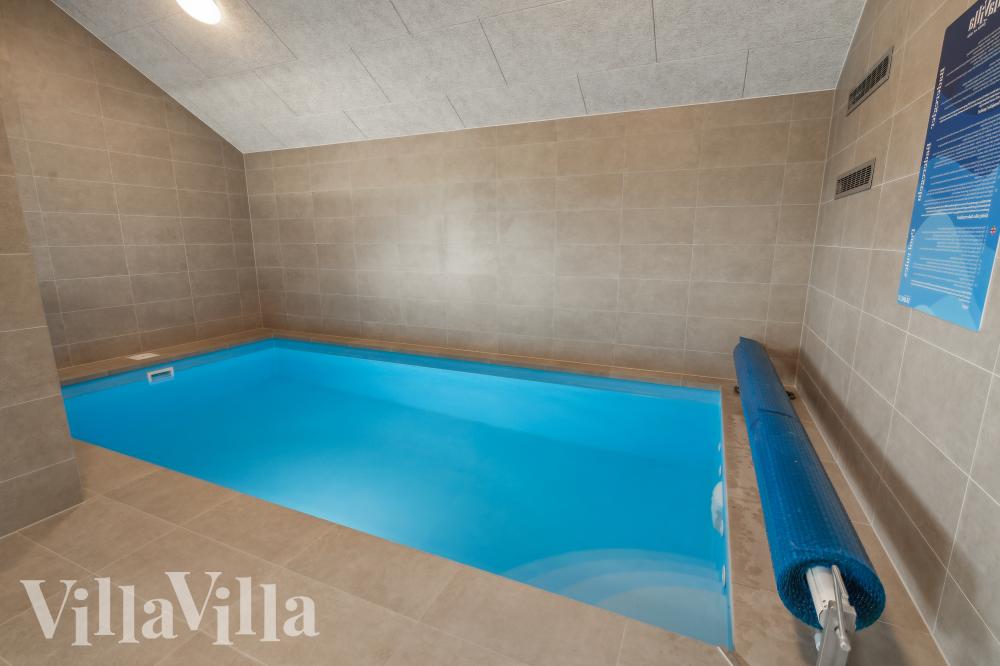 Das Ferienhaus 1015 hat einen schicken Poolbereich mit Wasserrutsche, einem geräumigen, eingelassenen Whirlpool und einer Sauna.
